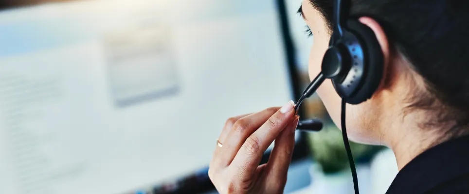 Woman talking on a headset at work